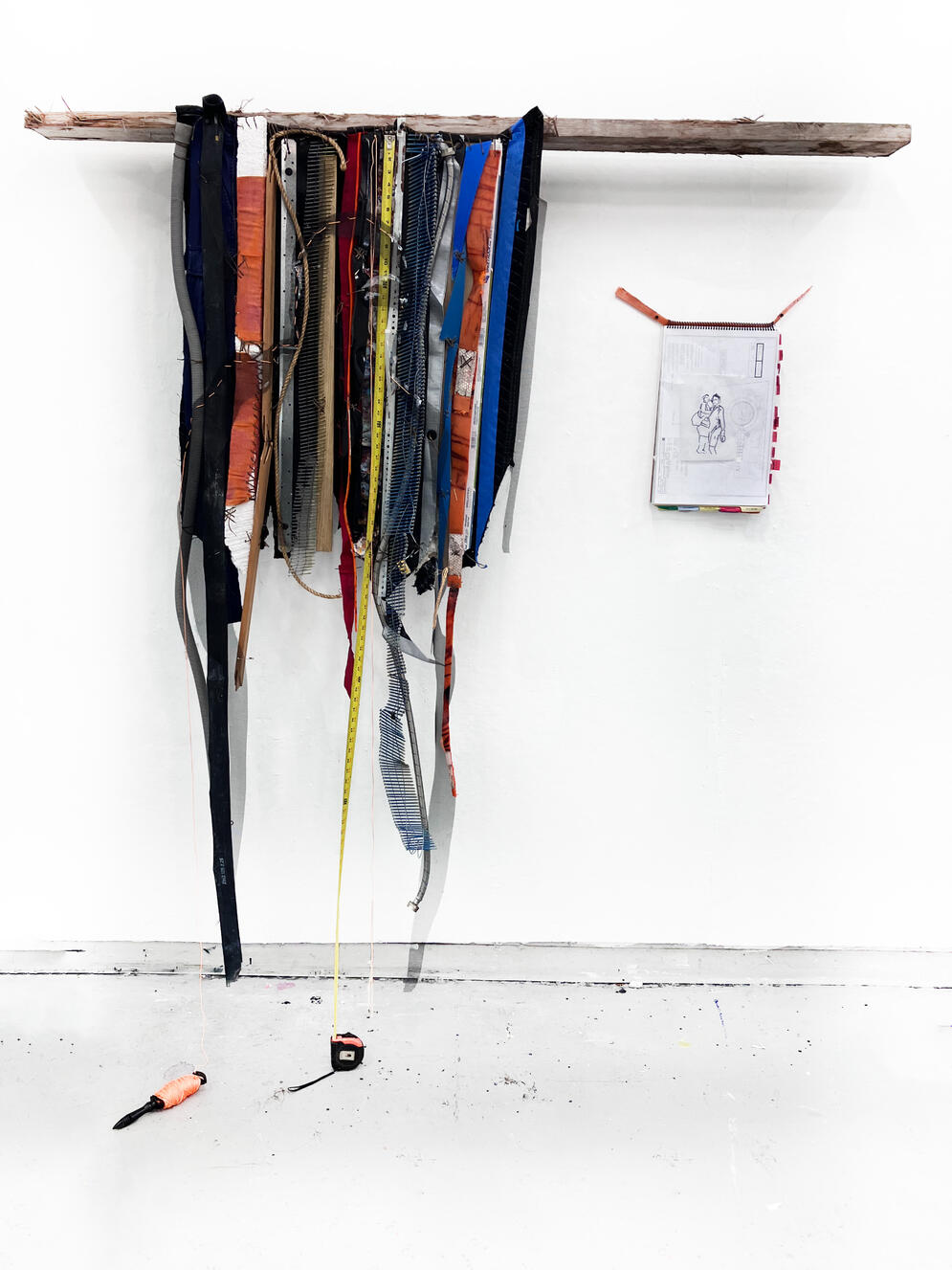 &quot;Rest in Power&quot; (with Human Drawings Artifact), 2024, Tape measure, inner tube, washer hose, moving blanket, plastic 55 gal drum, wood, nails, tarp, window screen, shop rag, sinew, metal, traffic cone, uniform, found objects, 8&#39; × 8&#39; × 8&quot;.