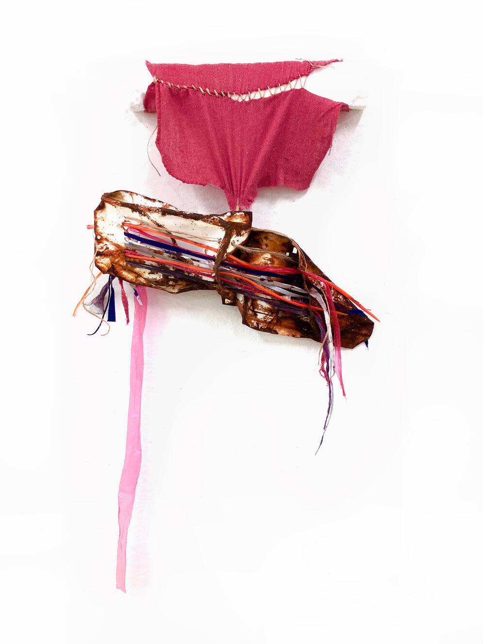 "Scrap Metal and Rag", 2024, Metal, enamel, cotton fabric, plastic, wood, nails, tarp, shop rag, sinew, traffic cone, uniform, wire, 20" × 32" × 4".