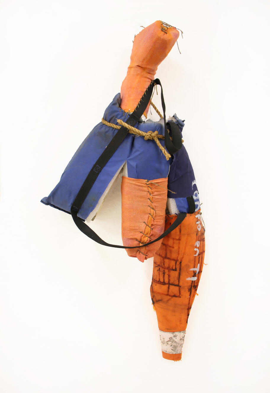 "Confio en Ti", 2024, shop rag, sinew, styrofoam, floatation device, traffic cone, rope, 22" × 38".